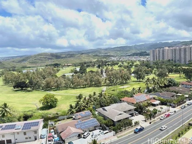 an aerial view of a house with garden space and ocean view