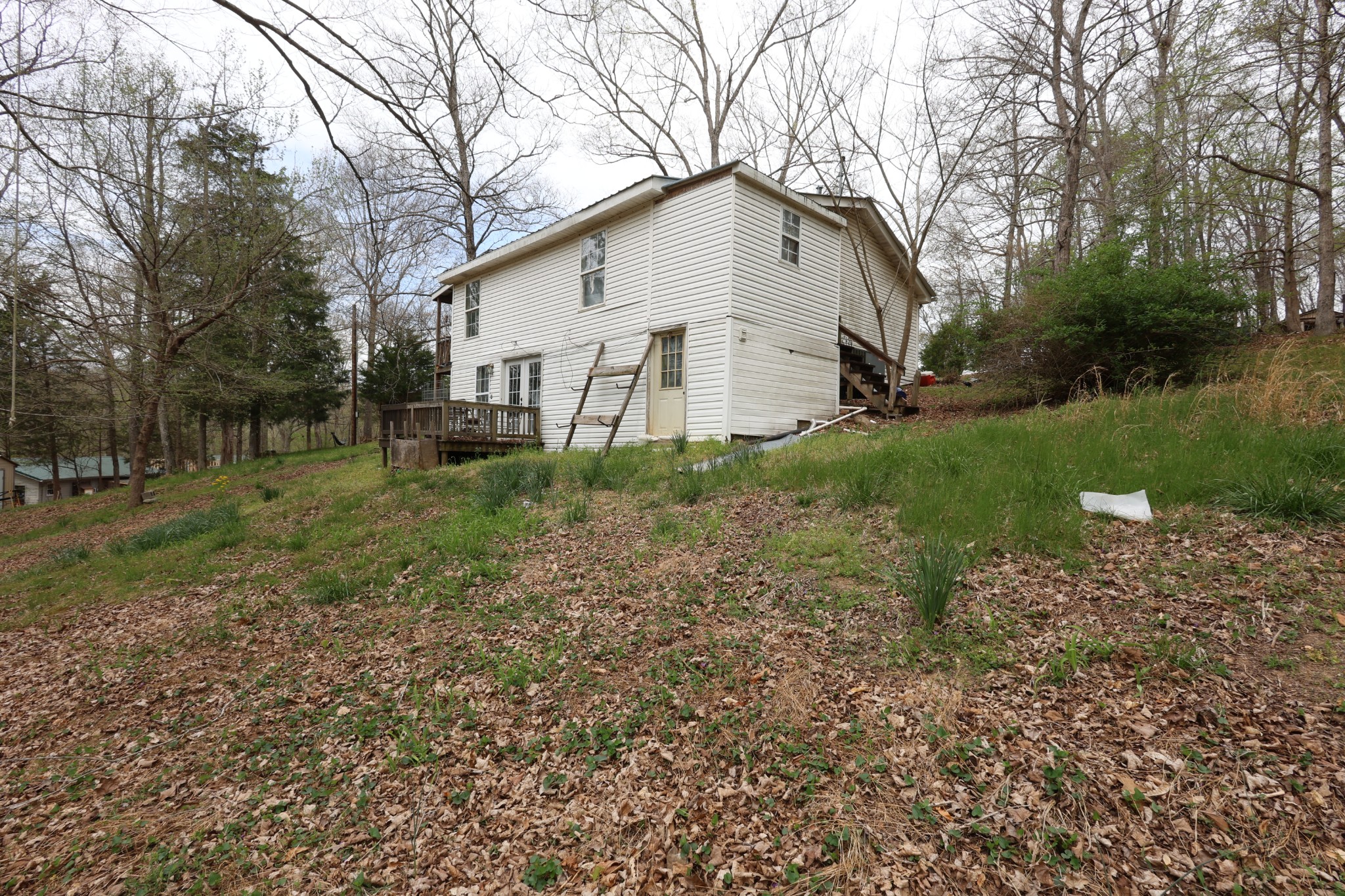 109 Furnace Hill Road Indian Mound, TN 37079 - Photo 10 of 17 a white house that has a small yard and large trees