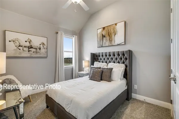a bedroom with a large bed and a painting on the wall