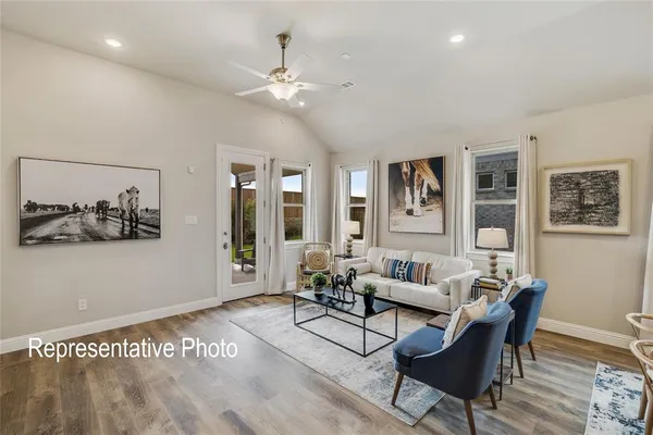 a living room with furniture and wooden floor