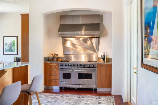 a kitchen with stainless steel appliances granite countertop a stove and a sink