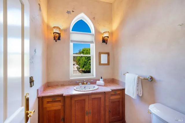 a bathroom with a granite countertop double vanity sinks and a mirror