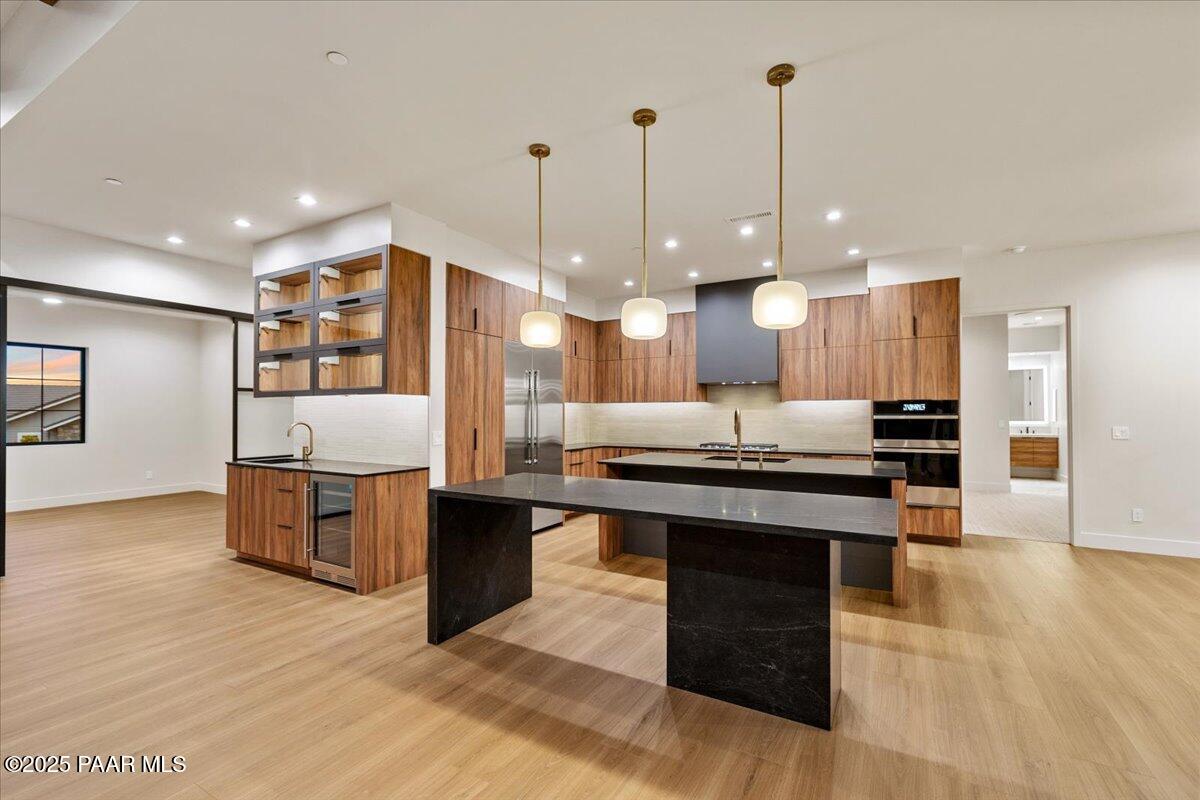 125 Rotonda Way Prescott, AZ 86301 - Photo 16 of 38 a large kitchen with stainless steel appliances kitchen island granite countertop a stove a sink a counter space and cabinets