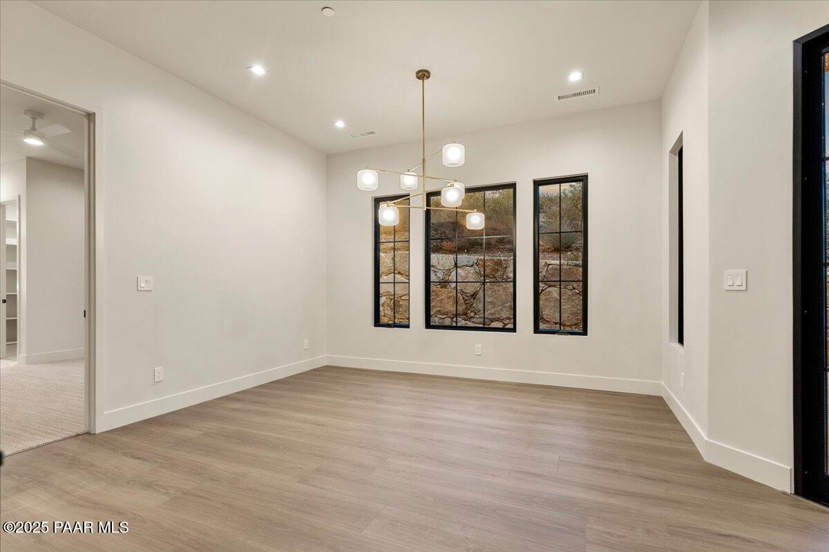125 Rotonda Way Prescott, AZ 86301 - Photo 22 of 38 an empty room with wooden floor and windows