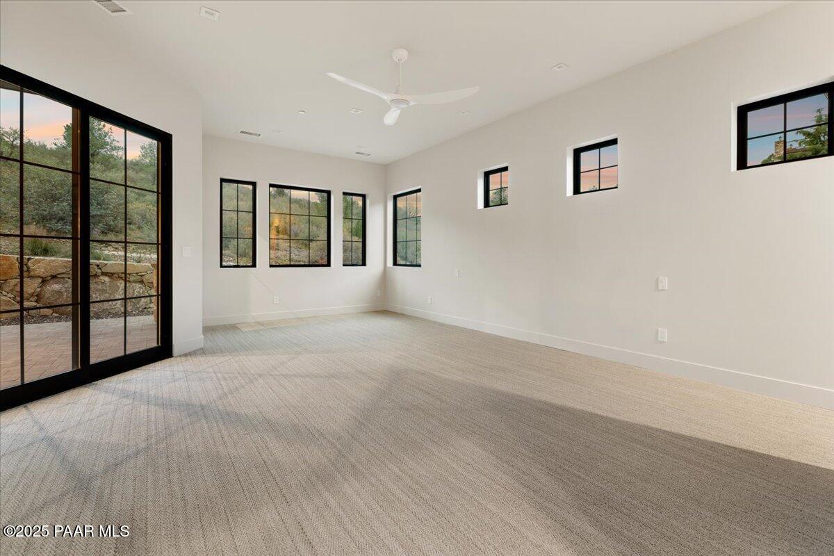 125 Rotonda Way Prescott, AZ 86301 - Photo 23 of 38 a view of an empty room with a window and wooden floor