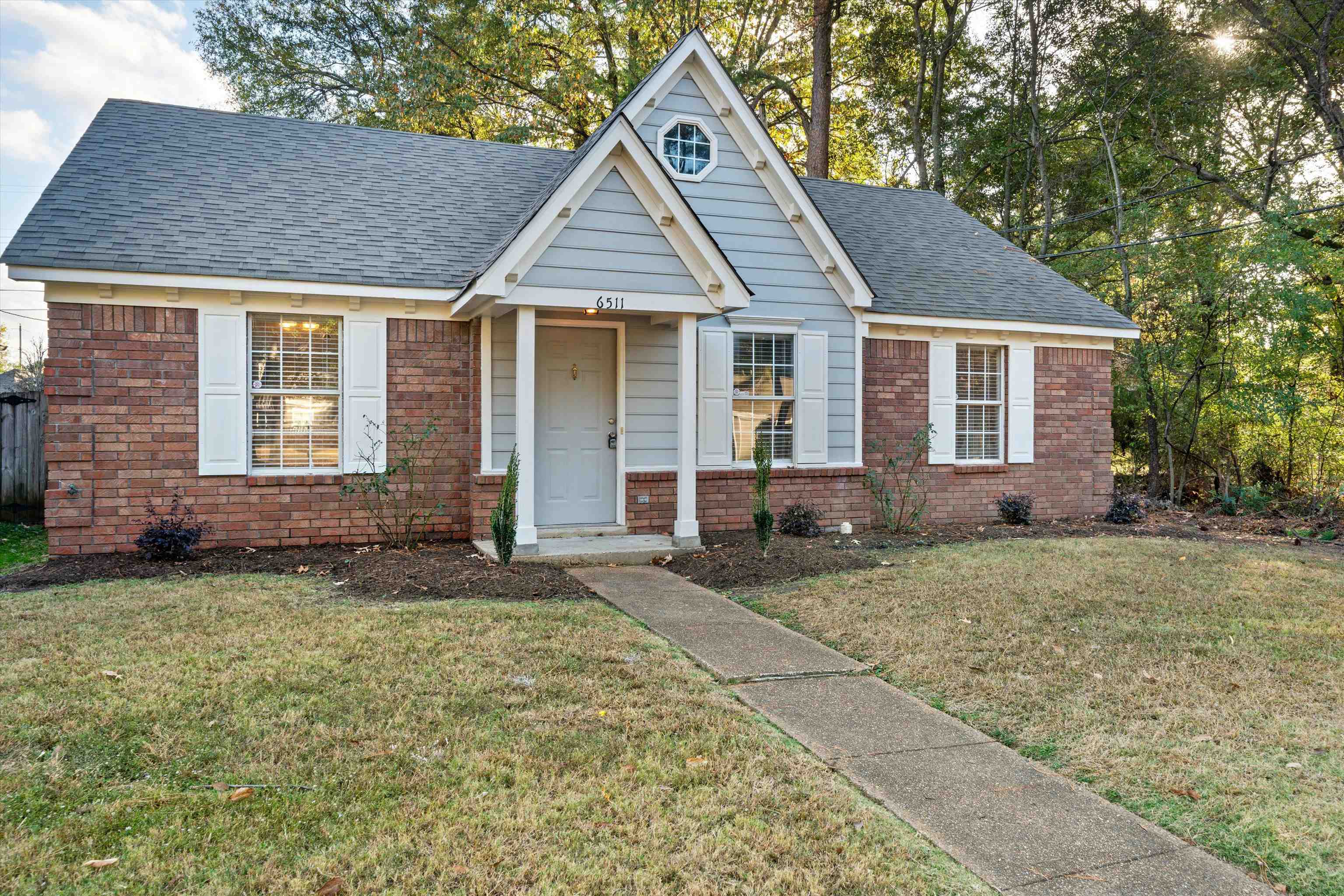 6511 Patmore Road Memphis, TN 38134 - Photo 1 of 22 a front view of a house with a garden