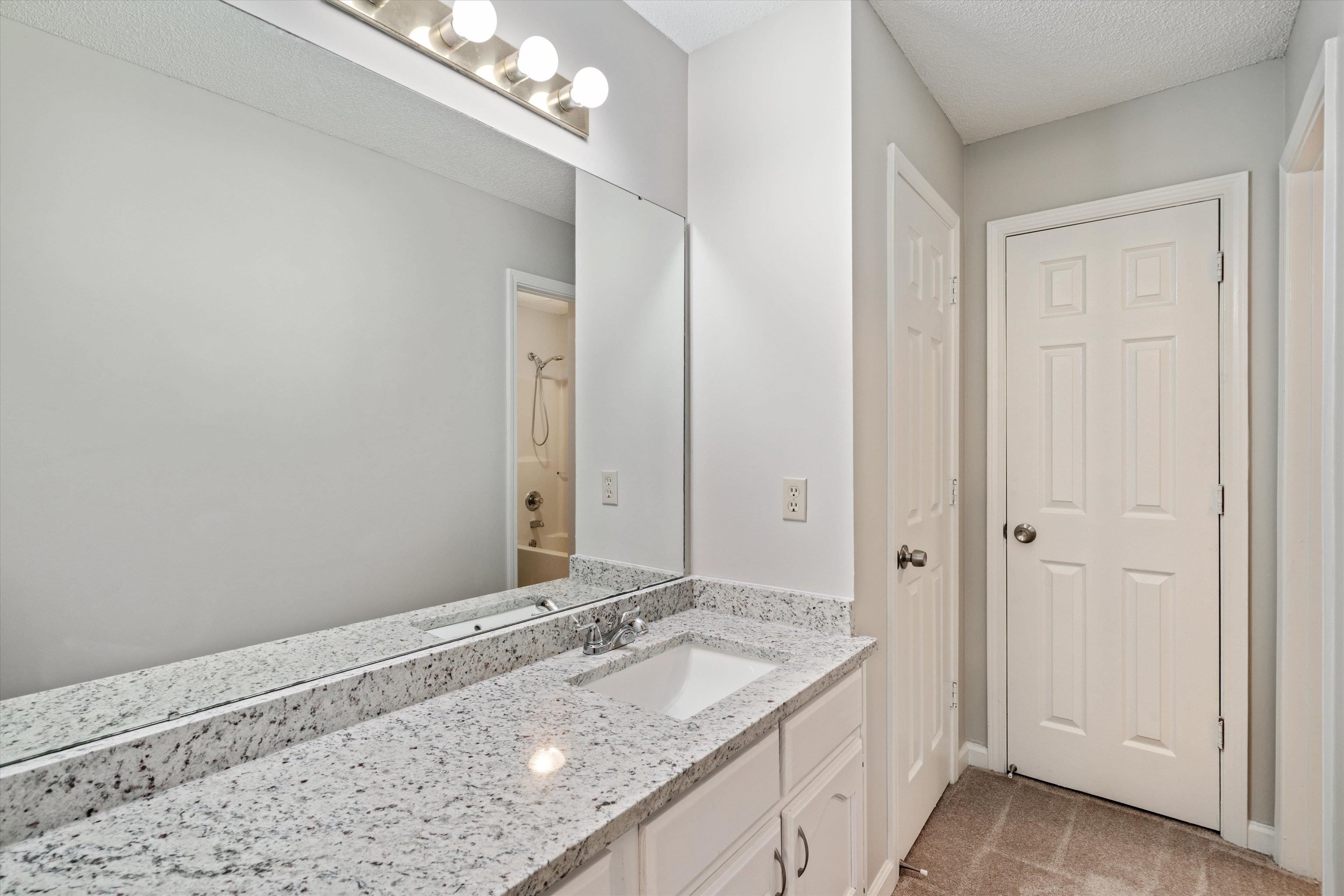 6511 Patmore Road Memphis, TN 38134 - Photo 13 of 22 a bathroom with a granite countertop sink and a mirror