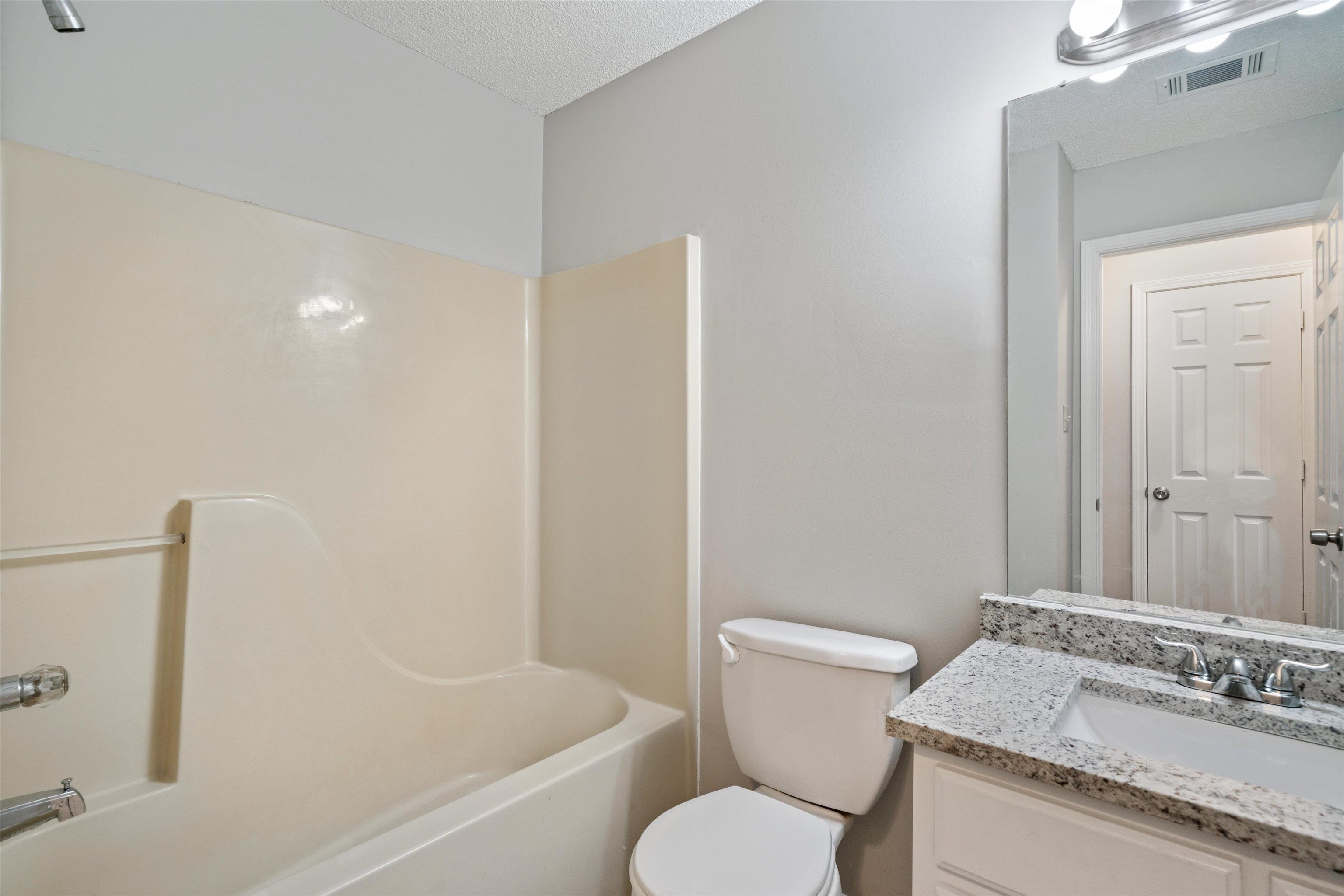 6511 Patmore Road Memphis, TN 38134 - Photo 17 of 22 a bathroom with a granite countertop sink toilet and shower