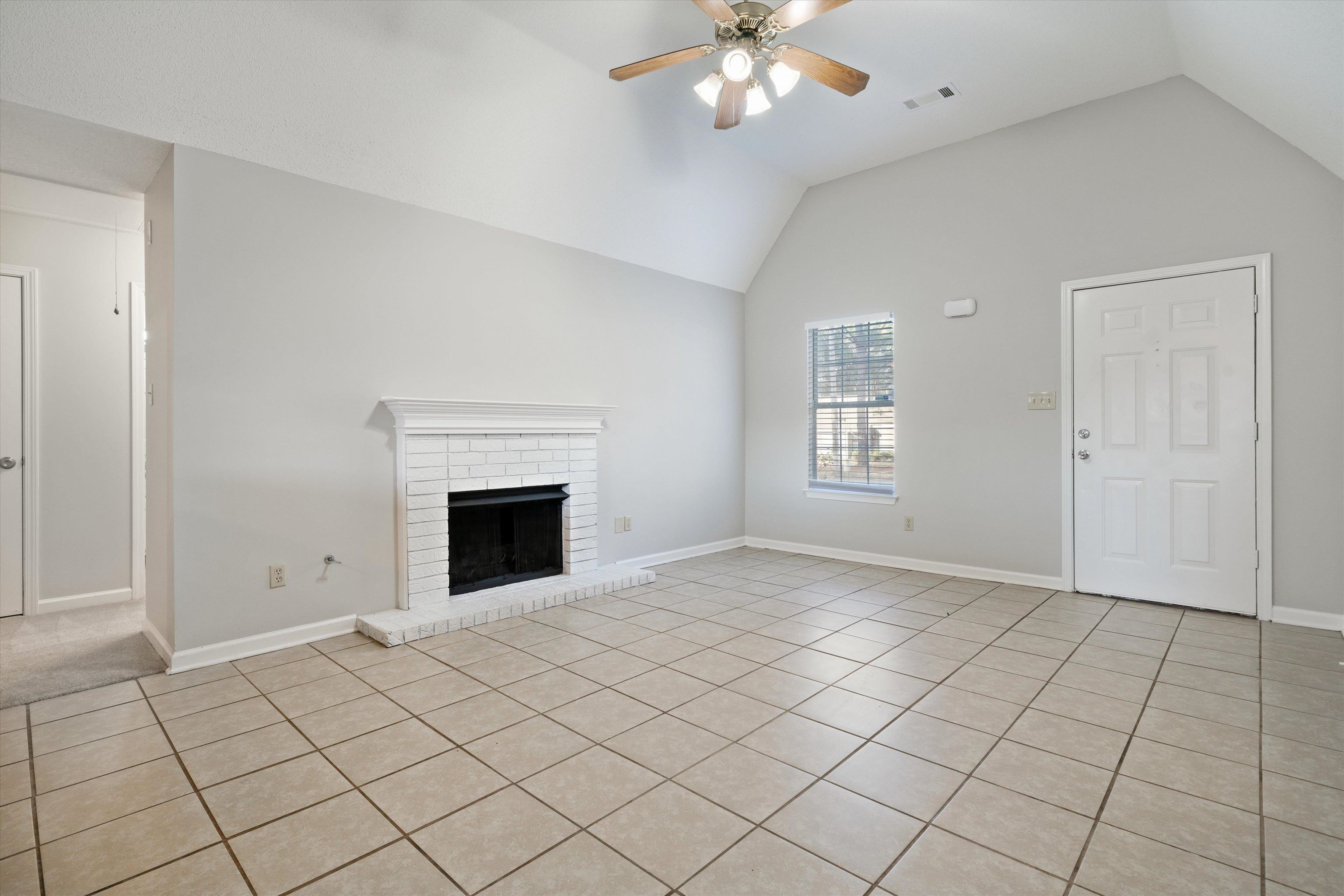 6511 Patmore Road Memphis, TN 38134 - Photo 4 of 22 a view of an empty room with window and chandelier fan