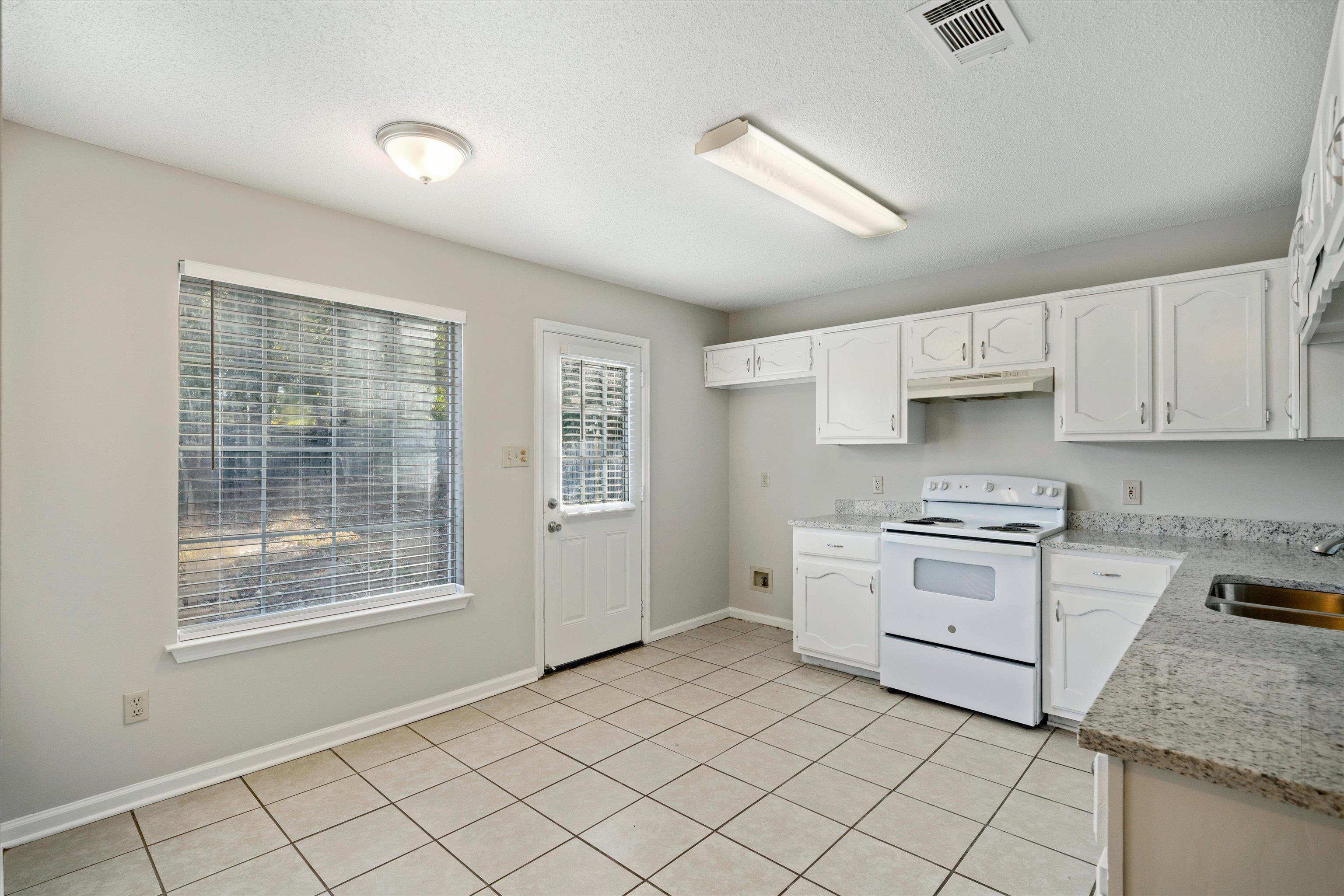 6511 Patmore Road Memphis, TN 38134 - Photo 6 of 22 a kitchen with a stove a sink and a refrigerator