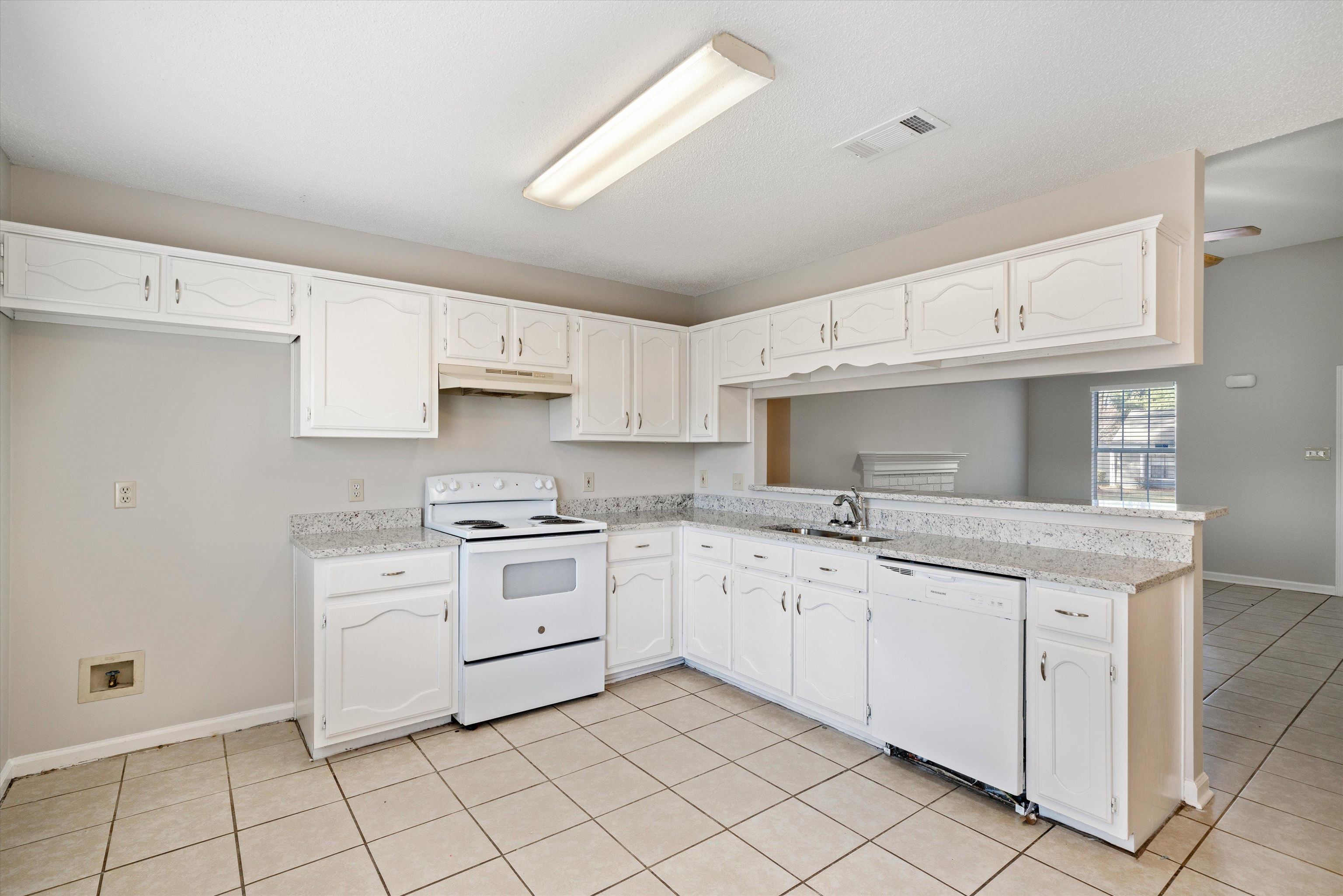 6511 Patmore Road Memphis, TN 38134 - Photo 7 of 22 a kitchen with granite countertop white cabinets and white appliances