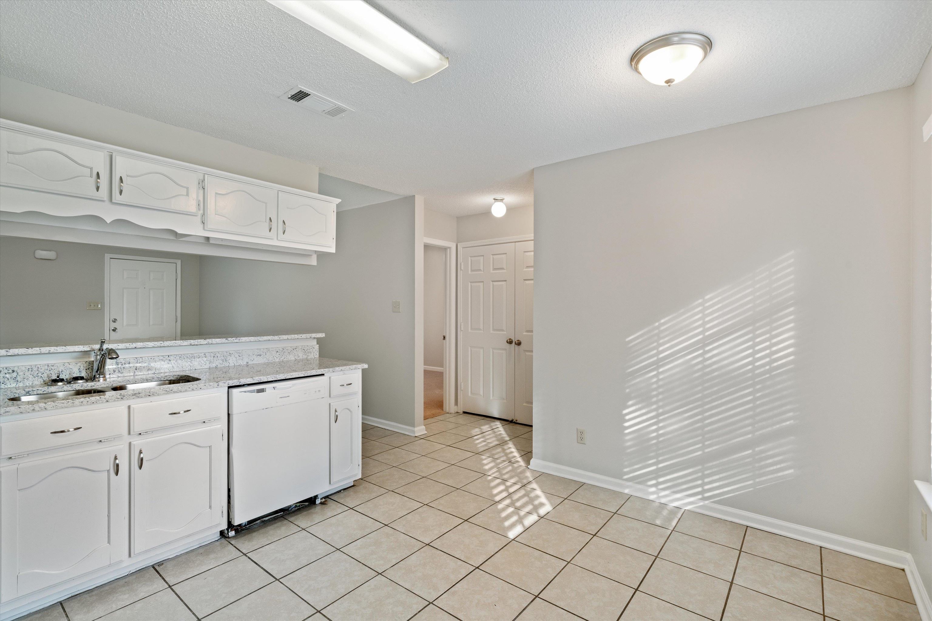 6511 Patmore Road Memphis, TN 38134 - Photo 8 of 22 a kitchen with granite countertop white cabinets and white appliances