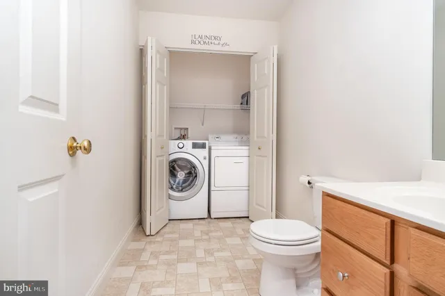 a bathroom with a sink a washer and dryer