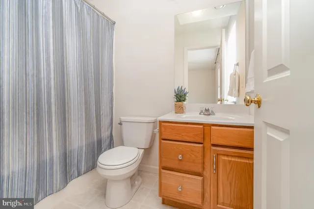 a bathroom with a toilet a sink and a mirror