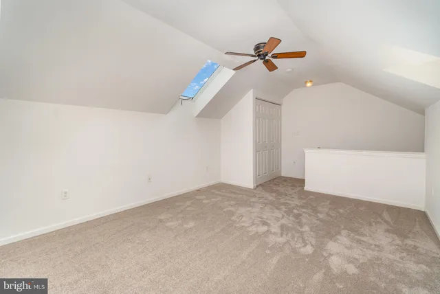 a view of a room with a ceiling fan