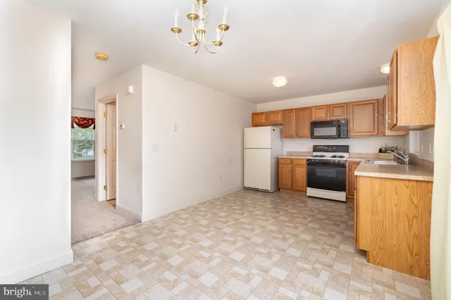a kitchen with a refrigerator a stove top oven a sink and dishwasher