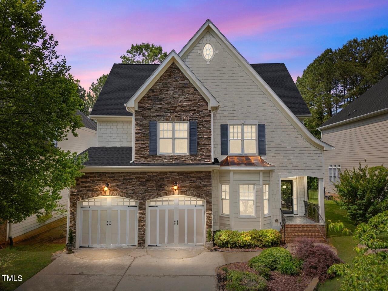 a front view of a house with a yard and garage
