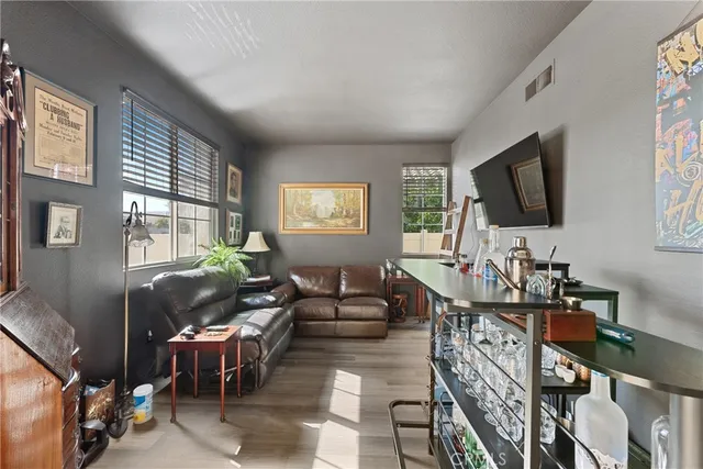 a living room with furniture a flat screen tv and a window