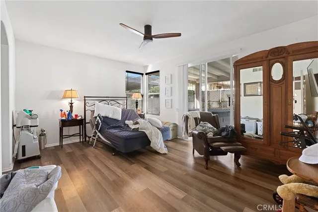 a living room with furniture a flat screen tv and a table
