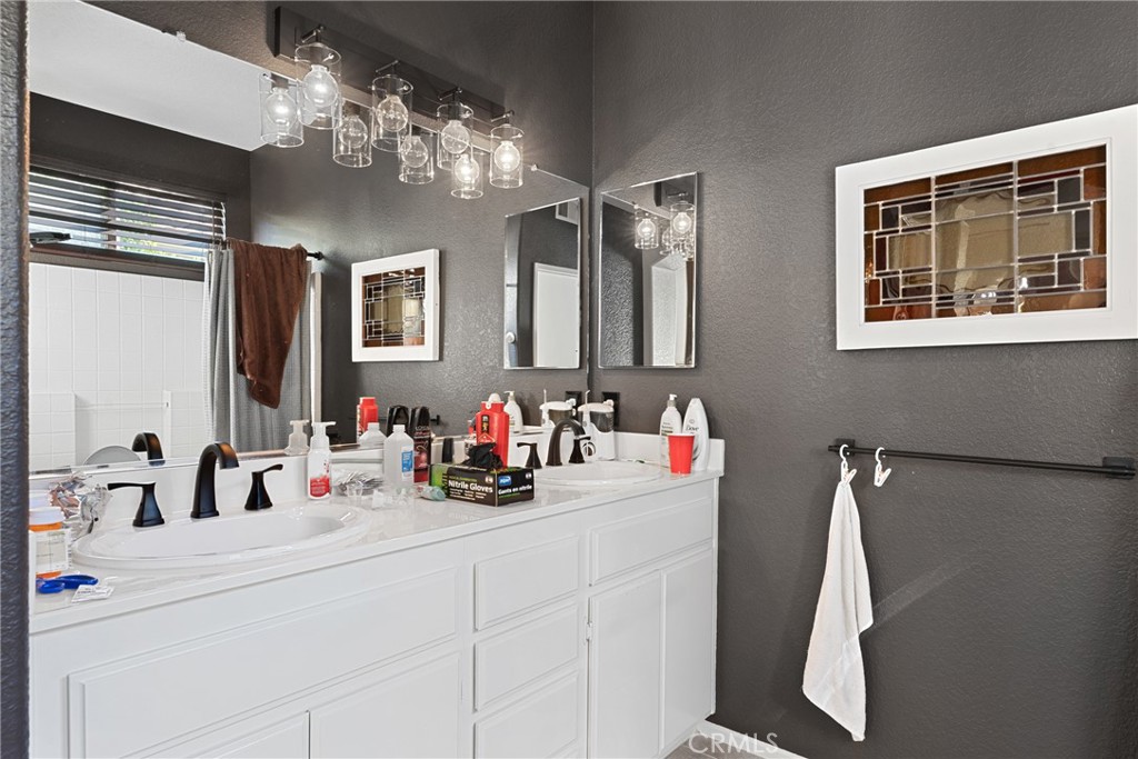 1851 Riviera Avenue Banning, CA 92220 - Photo 17 of 35 a bathroom with a sink double vanity and a mirror