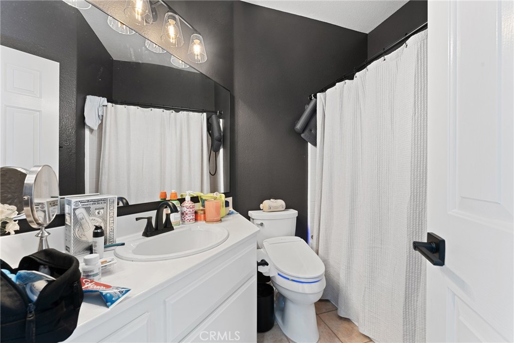 1851 Riviera Avenue Banning, CA 92220 - Photo 21 of 35 a bathroom with a toilet sink and mirror