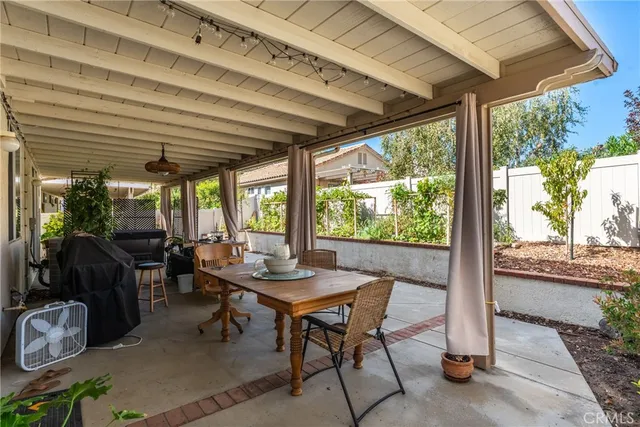 a view of a patio with table and chairs and potted plants