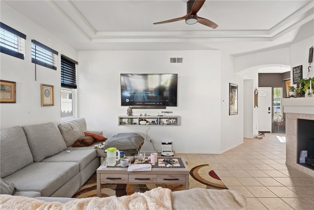1851 Riviera Avenue Banning, CA 92220 - Photo 5 of 35 a living room with furniture a flat screen tv and a chandelier
