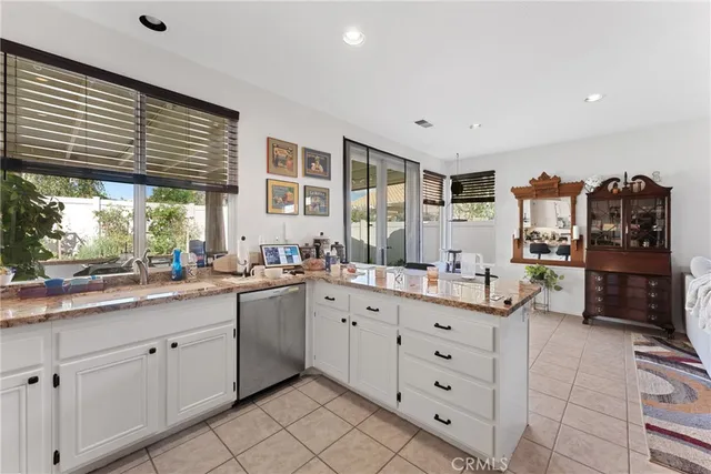 a large white kitchen with a large window