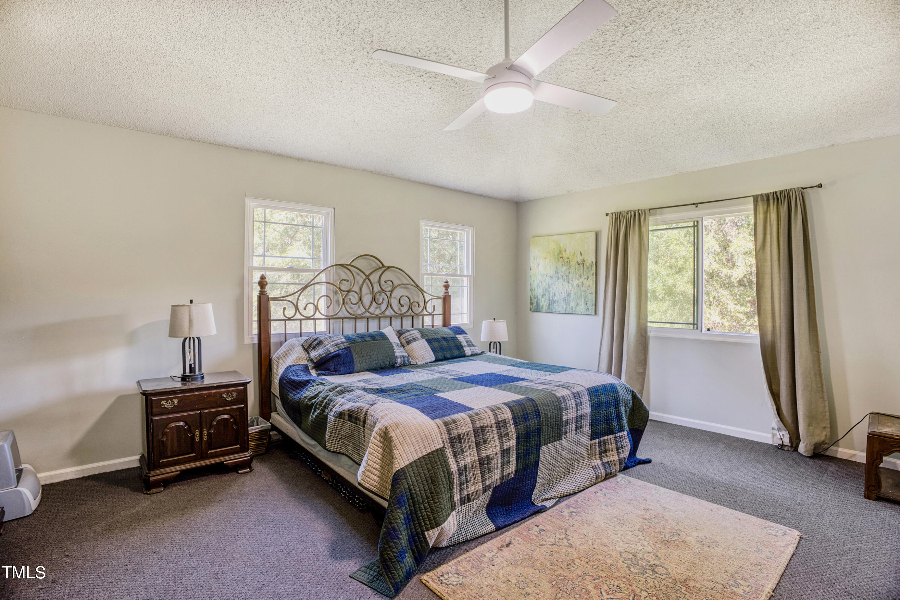 2650 Schloss Road Louisburg, NC 27549 - Photo 17 of 48 a bedroom with a bed and a chandelier