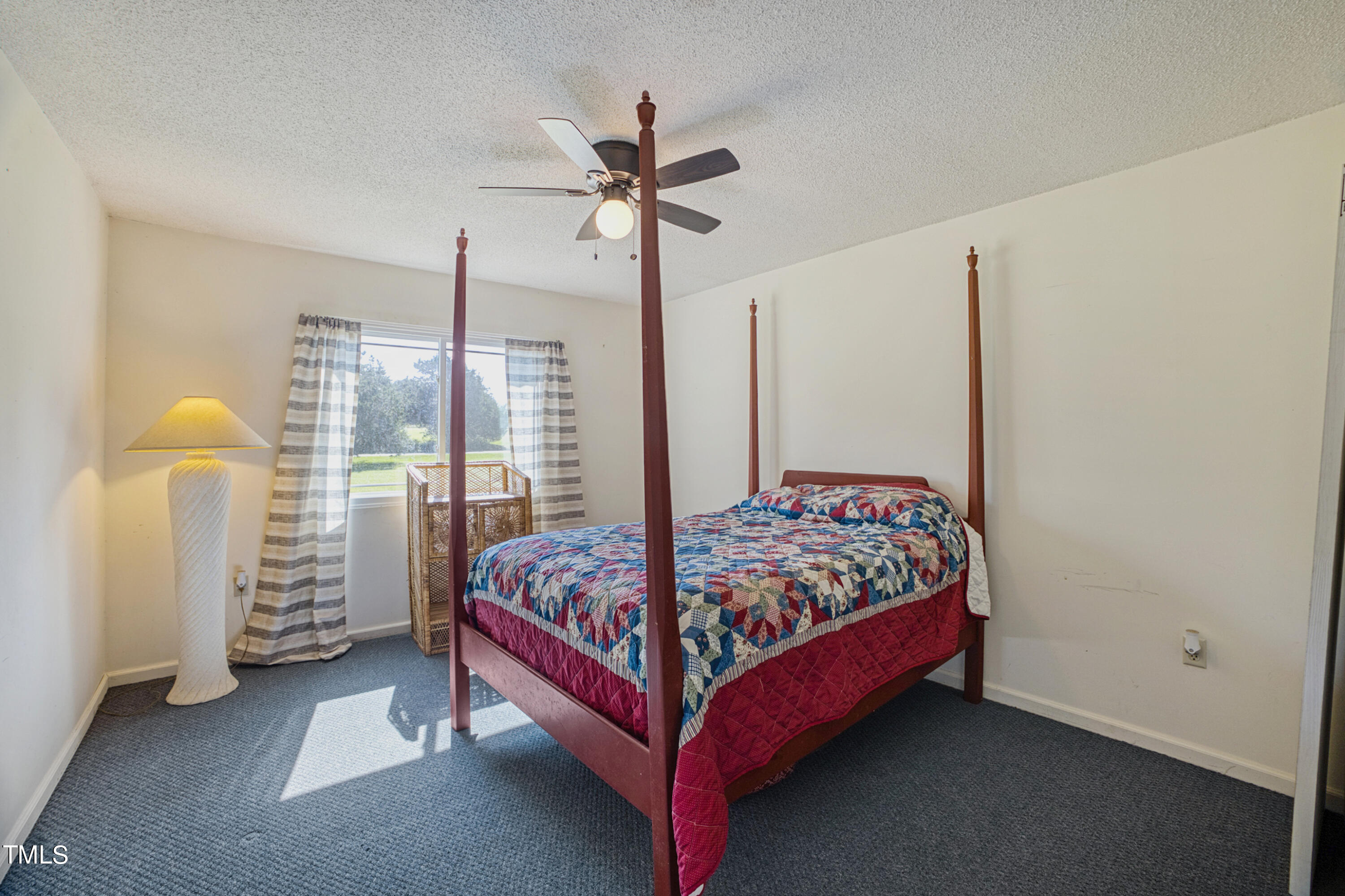 2650 Schloss Road Louisburg, NC 27549 - Photo 23 of 48 a bed sitting in a bedroom next to a lamp