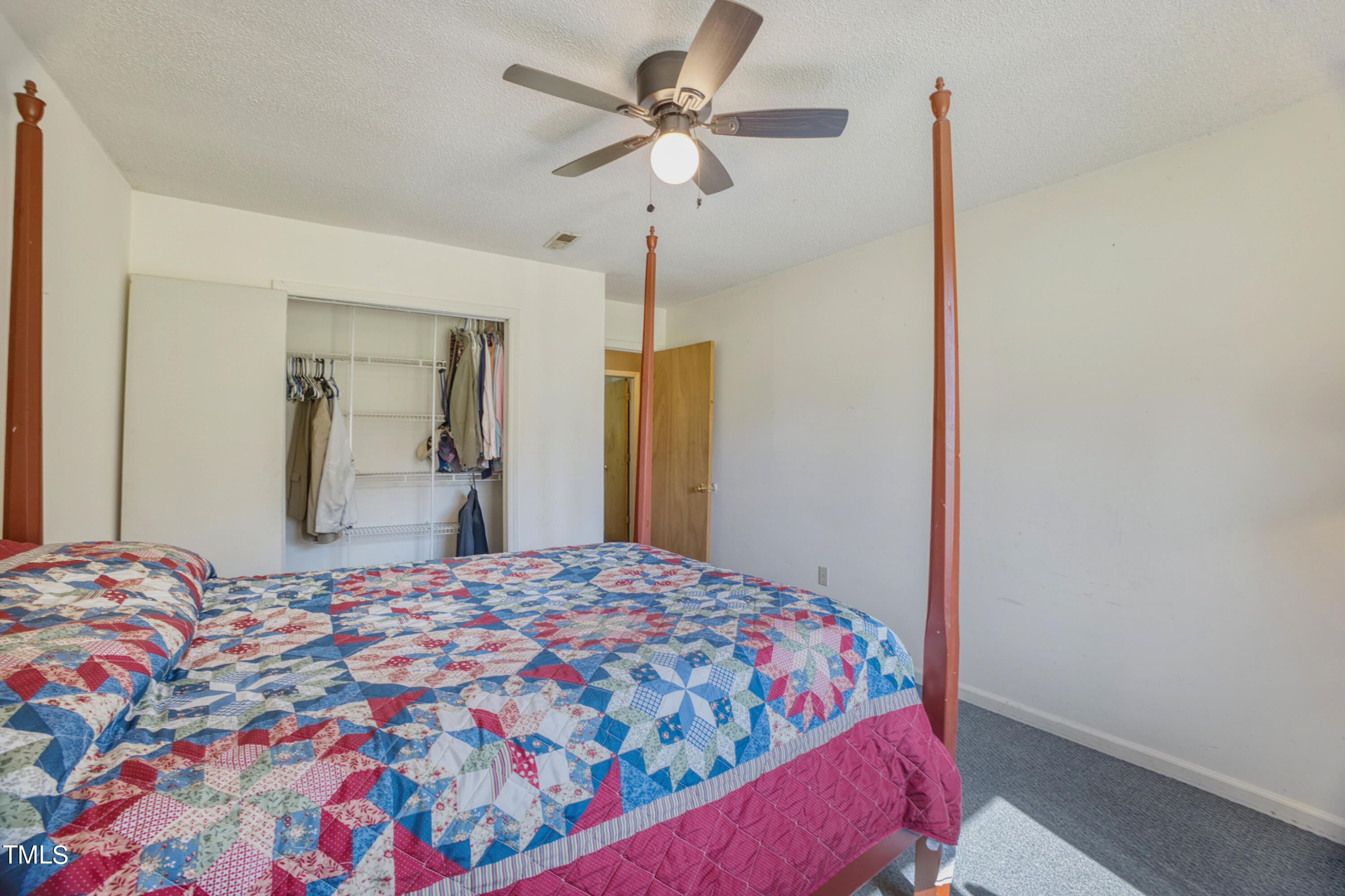 2650 Schloss Road Louisburg, NC 27549 - Photo 24 of 48 a bedroom with a bed and a chandelier