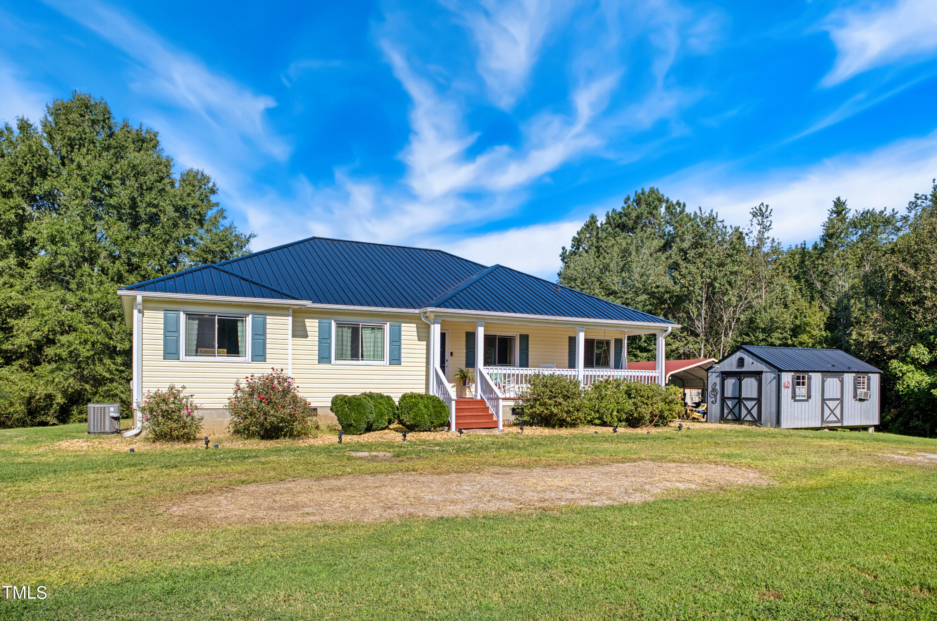 2650 Schloss Road Louisburg, NC 27549 - Photo 3 of 48 a front view of a house with a garden