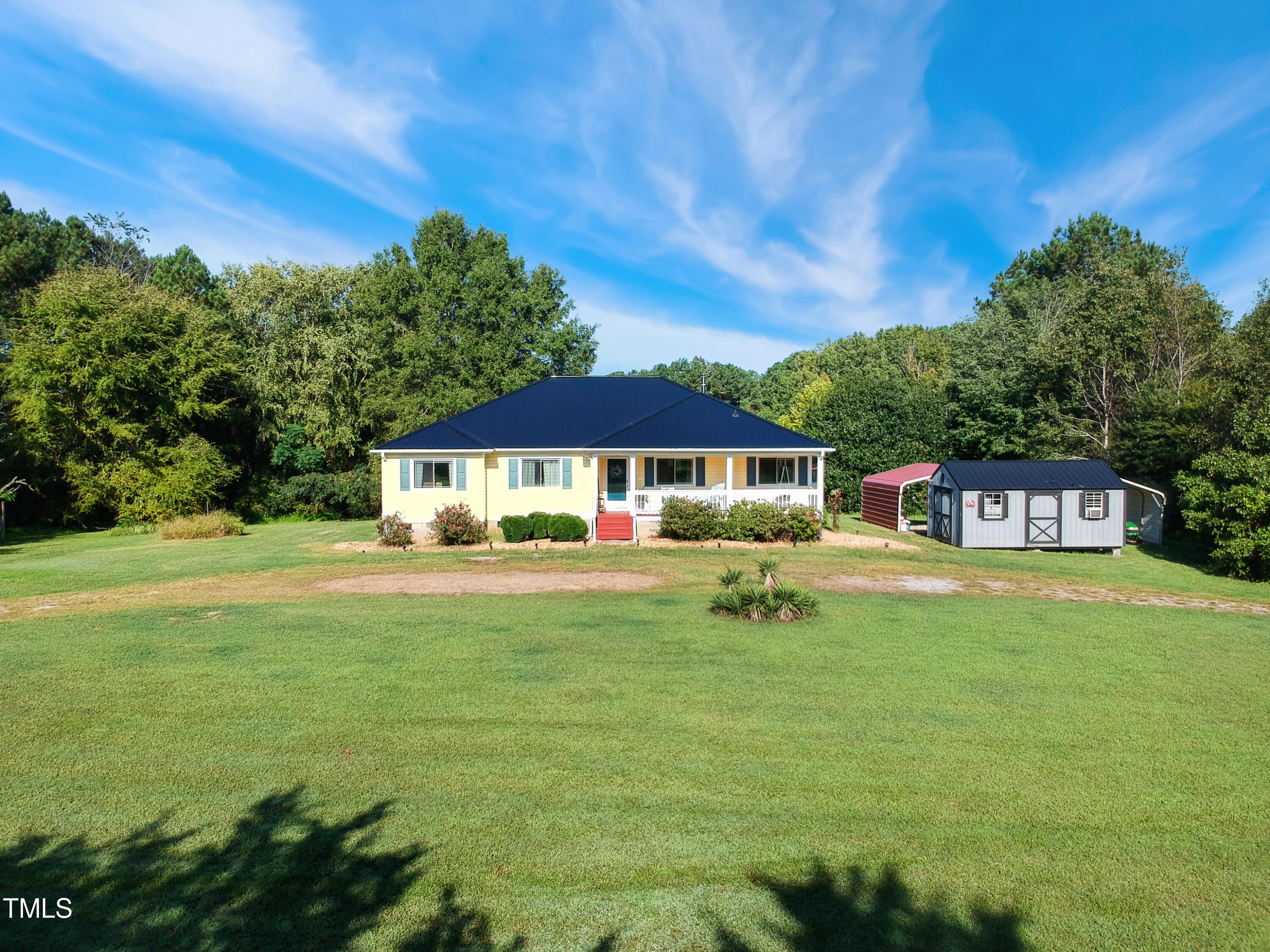 2650 Schloss Road Louisburg, NC 27549 - Photo 4 of 48 a front view of a house with a garden