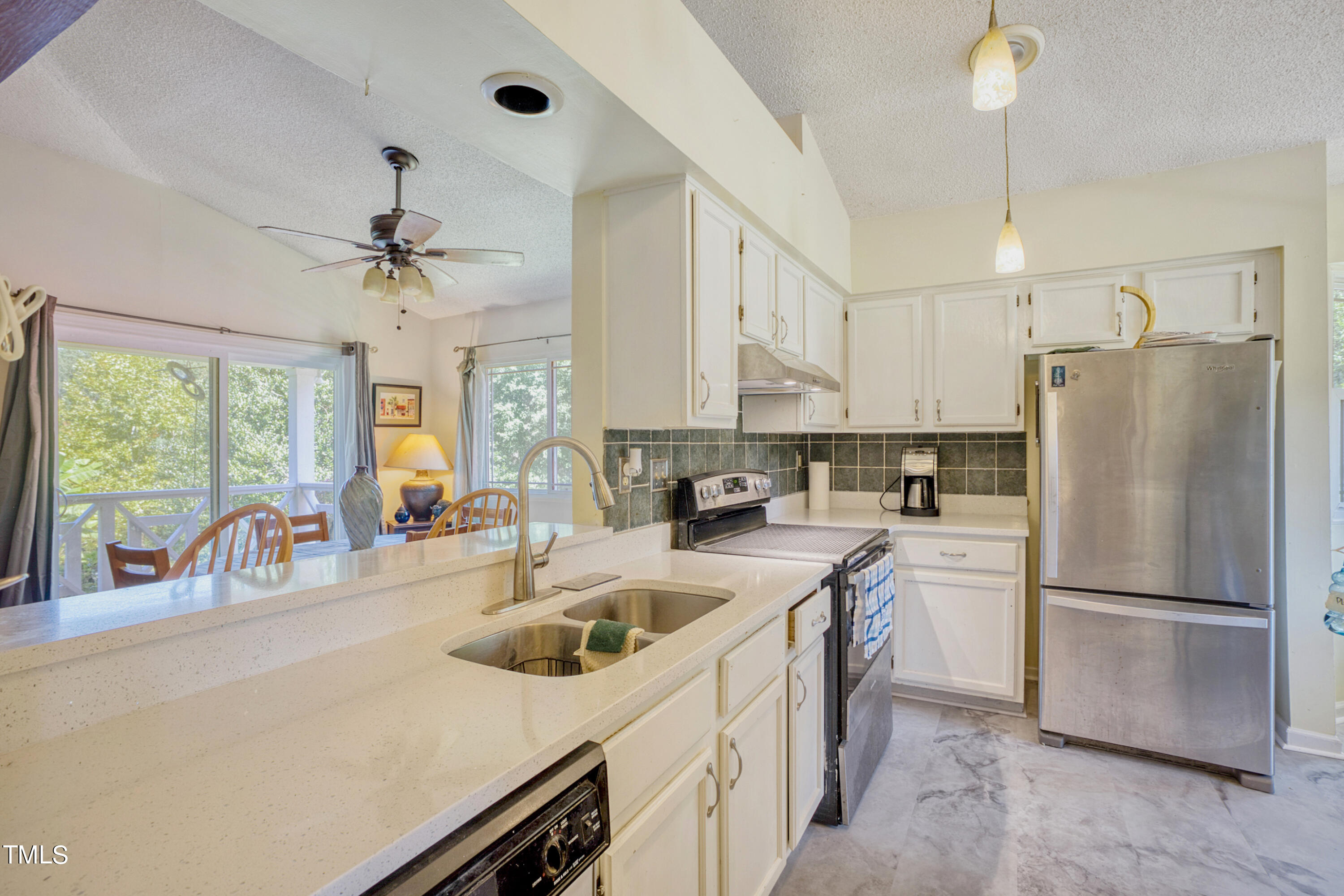 2650 Schloss Road Louisburg, NC 27549 - Photo 10 of 48 a kitchen with refrigerator a sink and cabinets