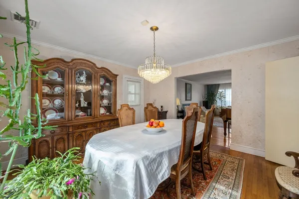 a view of a dining room with furniture and a chandelier