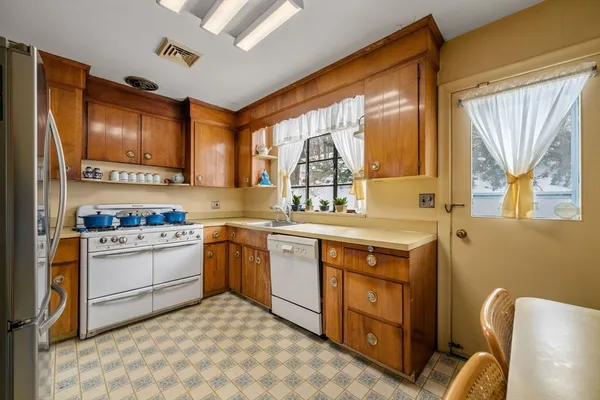 a kitchen with a stove a sink and a refrigerator