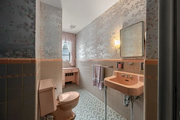 a bathroom with a sink a toilet and mirror