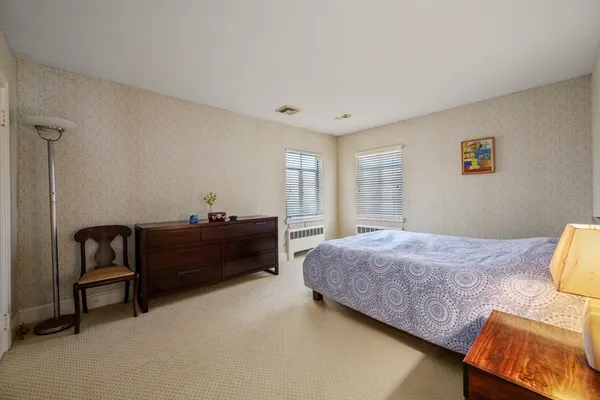a bed room with a bed and a window