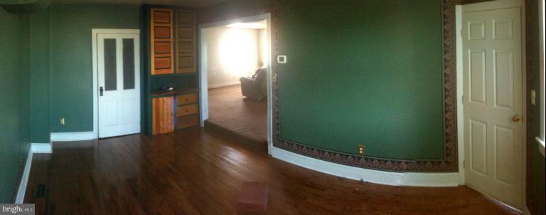 981 Otterdale Mill Road Taneytown, MD 21787 - Photo 2 of 14 an empty room with wooden floor and a bathroom