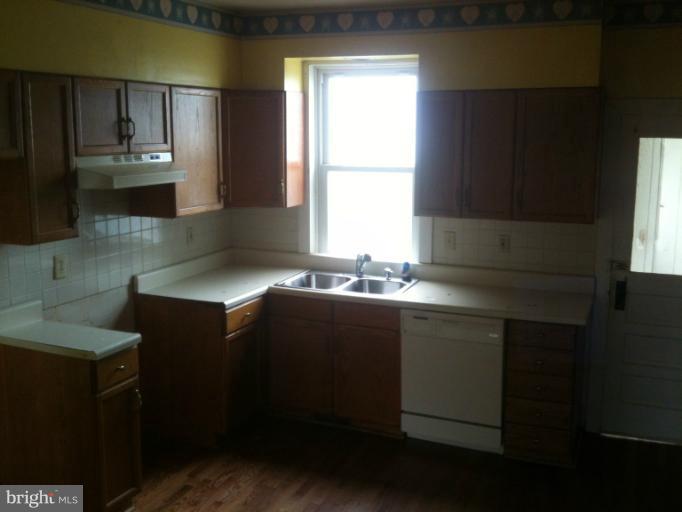 981 Otterdale Mill Road Taneytown, MD 21787 - Photo 12 of 14 a kitchen with a sink a window and cabinets