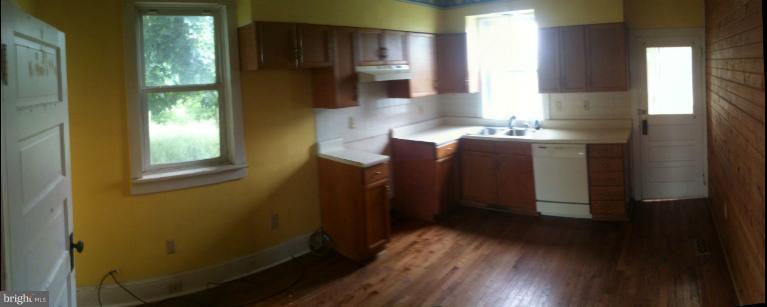981 Otterdale Mill Road Taneytown, MD 21787 - Photo 3 of 14 a kitchen with kitchen island wooden floor and window