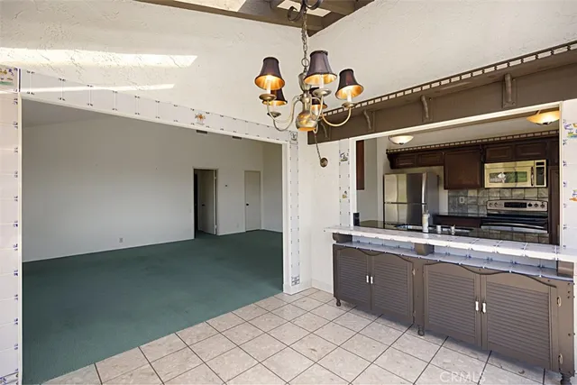 a kitchen with stainless steel appliances granite countertop a sink a stove and a refrigerator