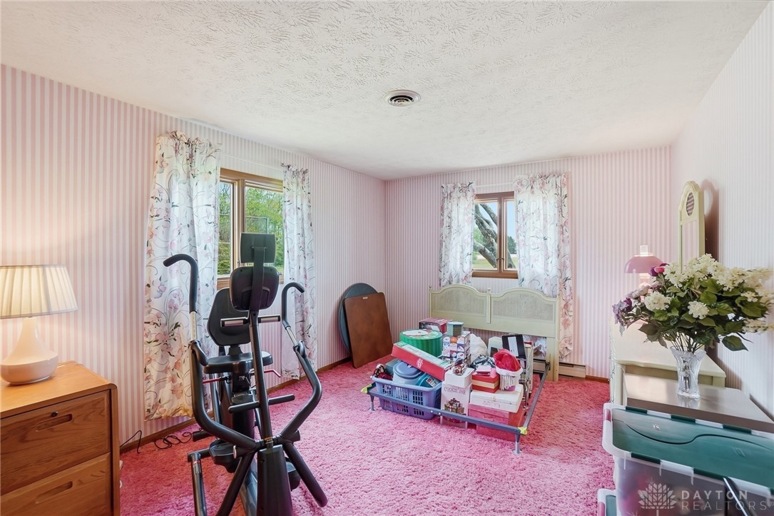 5669 O Neall Road Waynesville, OH 45068 - Photo 38 of 72 This cozy bedroom features plush carpeting and abundant natural light through charming windows.