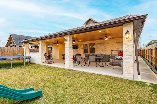 a swimming pool with outdoor seating yard and barbeque oven