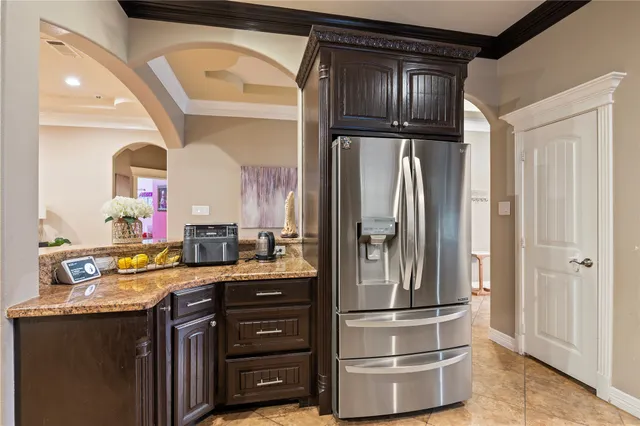 a kitchen with stainless steel appliances granite countertop a refrigerator and a sink
