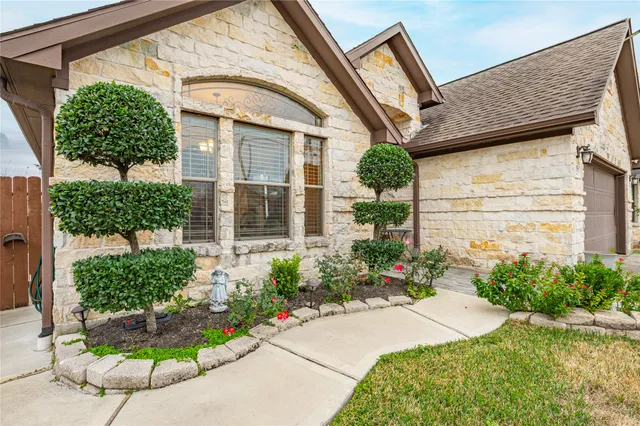 a front view of a house with garden