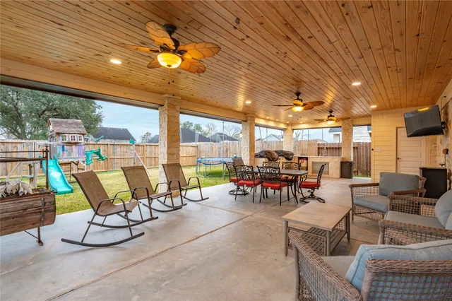 a view of a dining room with furniture and floor to ceiling window