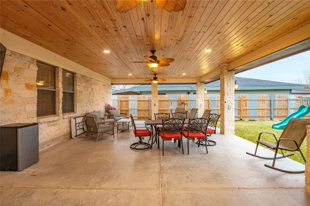 a view of a patio with table and chairs