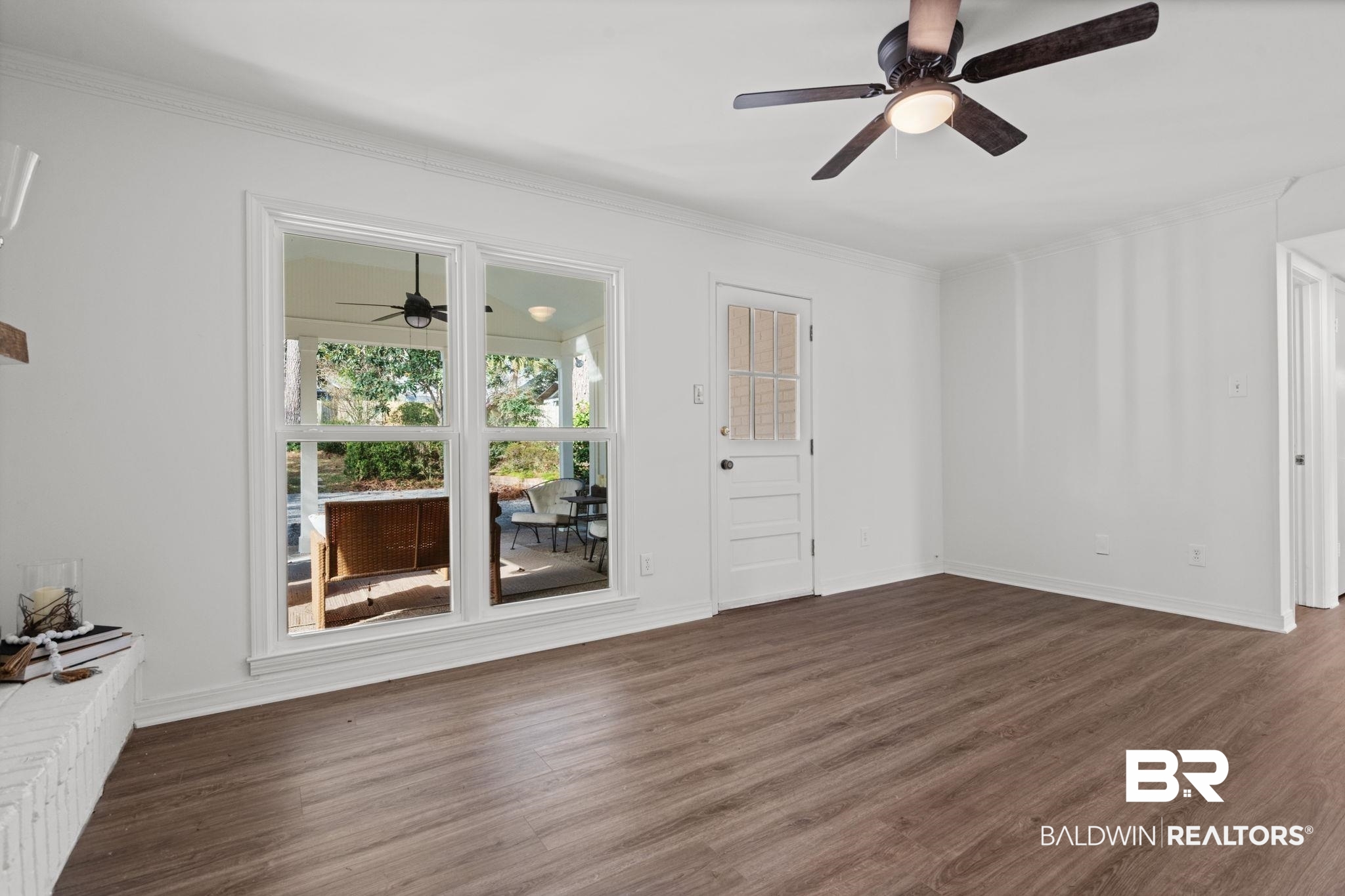 511 Wacker Lane North Mobile, AL 36608 - Photo 17 of 45 Unfurnished living room featuring ceiling fan, dark wood-type flooring, and ornamental molding