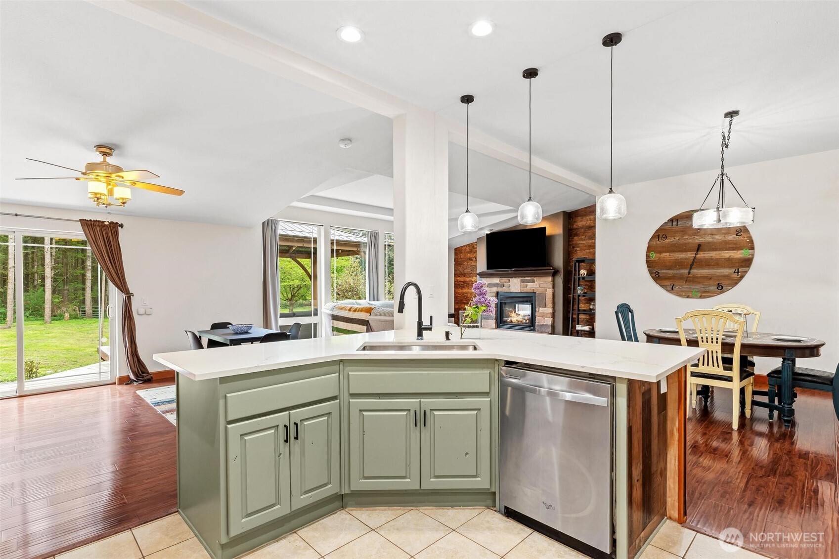 4915 Schwarzmiller Road Lake Stevens, WA 98258 - Photo 11 of 40 a kitchen with a sink a stove and a dining table with garden view